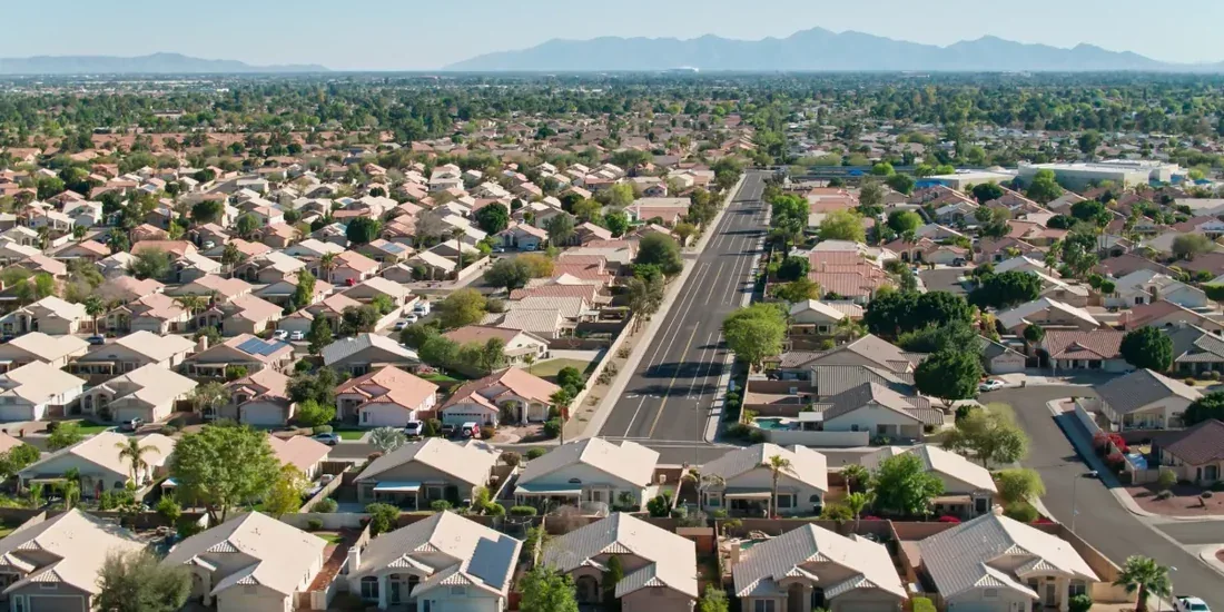 Aerial view of a Scottsdale neighborhood with mountains beyond